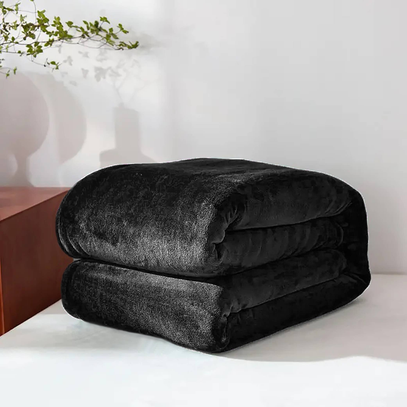 Folded black plush flannel blanket in a thick, rolled stack