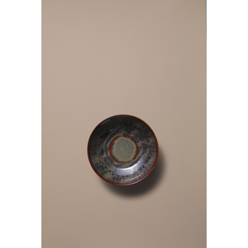 Coupe bowl, top view showing circular center on dark blue-gray speckled glaze