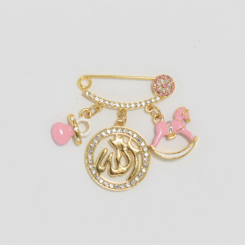 Gold-tone baby pin with pink heart, round emblem, and rocking-horse dangling charms