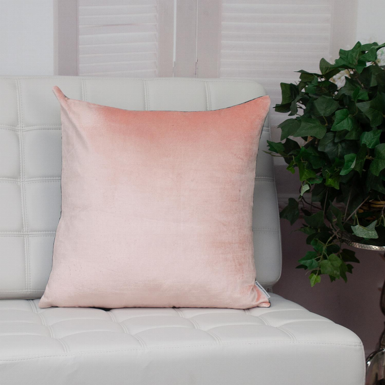 Pink throw pillow with square shape, subtle sheen, and neatly stitched border.