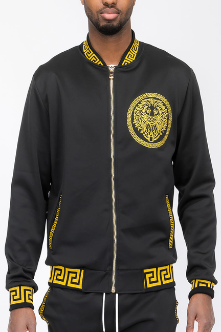 Black track jacket with gold lion emblem, full zip front, and matching Greek border cuffs