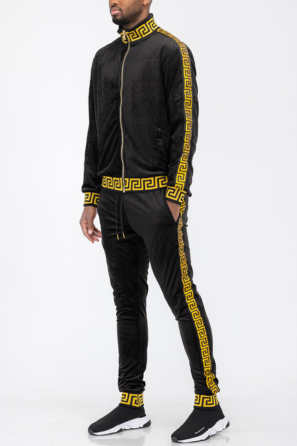 Black velour track set with gold trim, Greek key stripe, and matching cuffs and pants