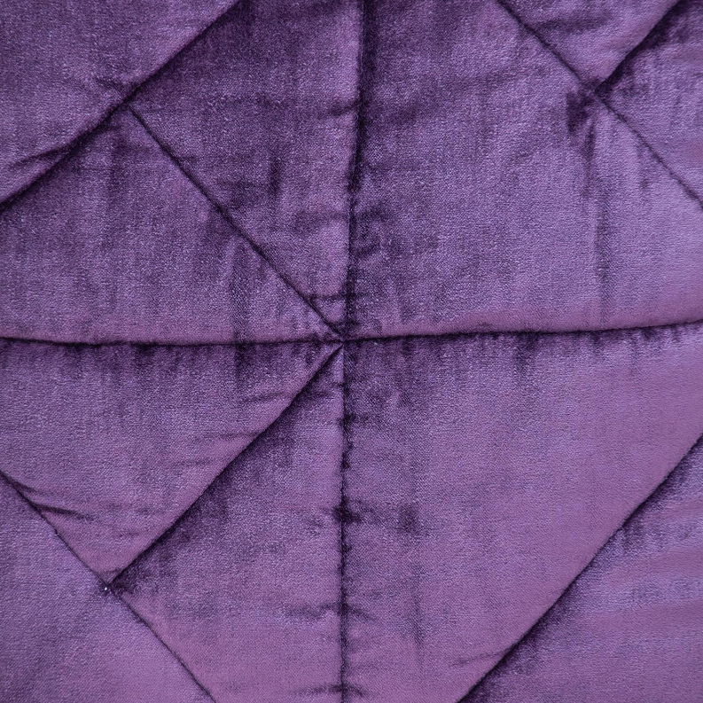 Purple velvet quilted throw pillow close-up of diamond stitched panels