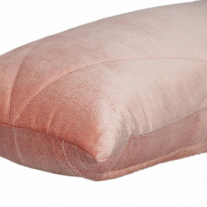 Light pink pillow close-up showing stitched seams and quilted channel pattern