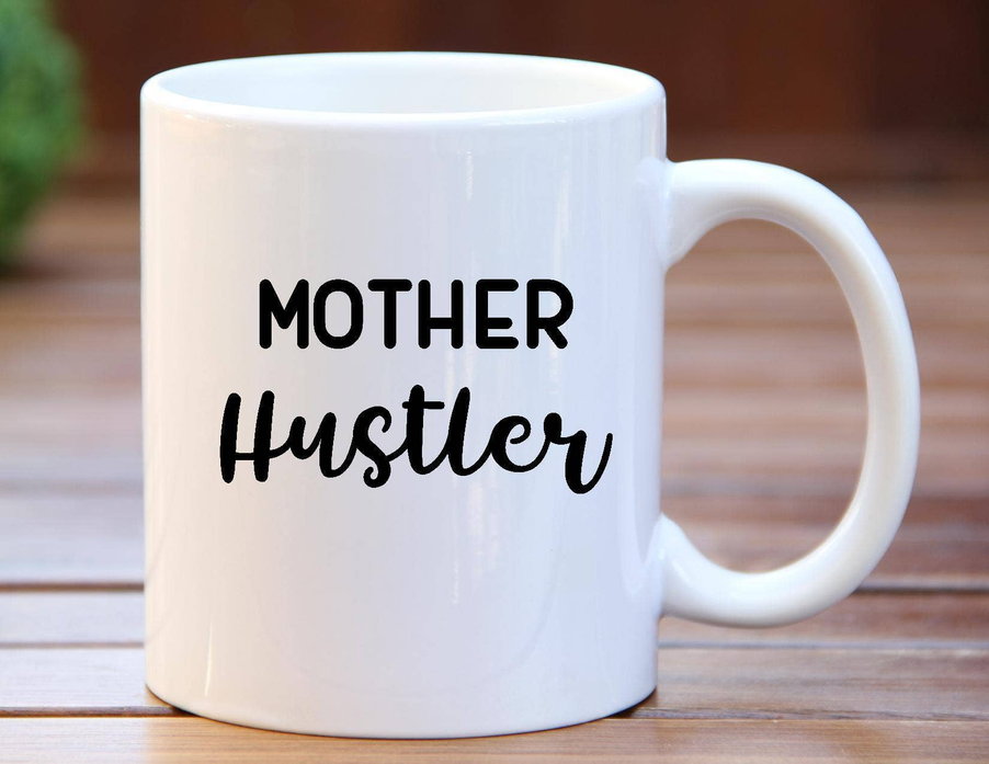 White 11oz coffee mug with 'MOTHER Hustler' print and side handle