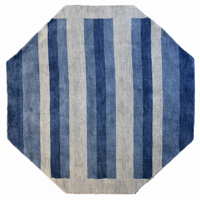 Octagon area rug with vertical blue and light gray stripes on a neutral base