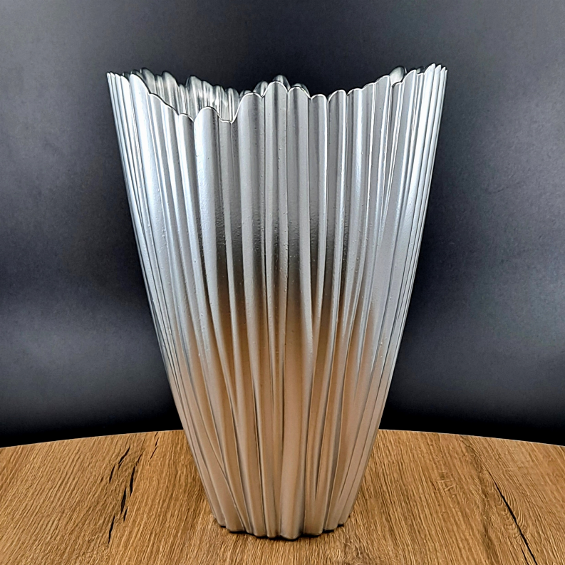Clear glass vase with vertical fluted sides and reflective silver ridges