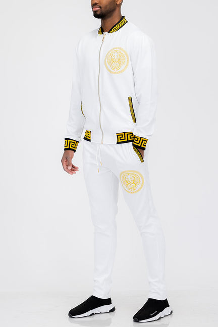 White track set with gold lion head emblem, zip jacket and pants with matching trim