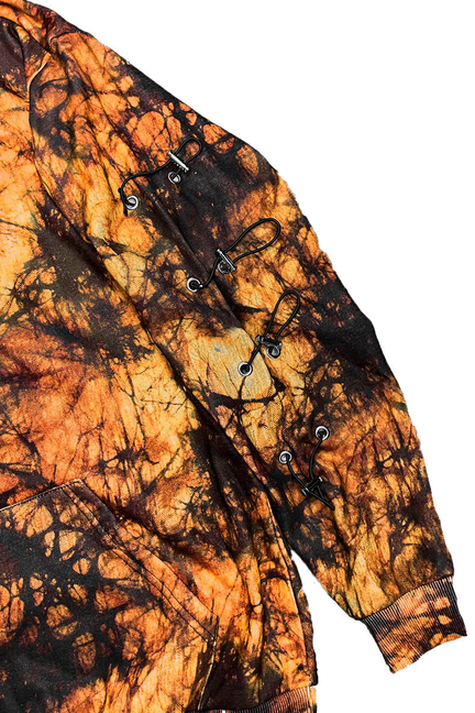 Orange and black tie-dye hoodie with buttoned front placket and toggle hardware