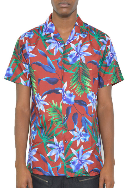 Short sleeve button-up shirt with tropical floral print, red base, green leaves, blue flowers