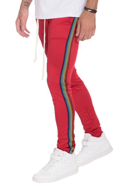 Men's red track pants with multicolor rainbow side stripe and ribbed cuffs