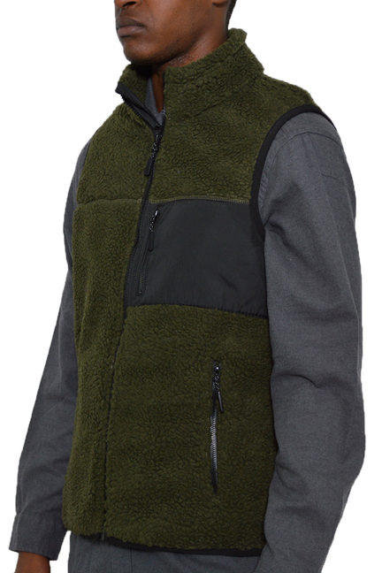 Olive sherpa full-zip vest with dark paneling and two zip pockets