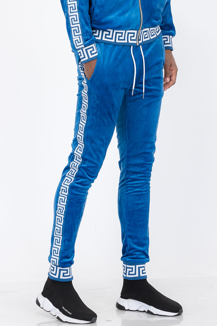 Status velour track pants in blue with white Greek-key trim and drawstring waist