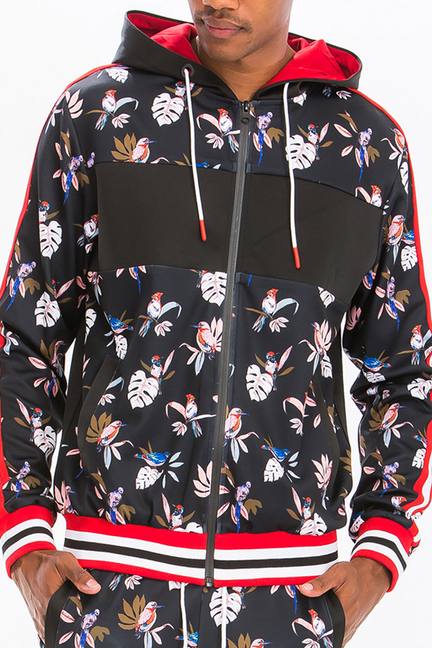 Black floral print zip-up track hoodie with hood, red drawstring, and striped hem