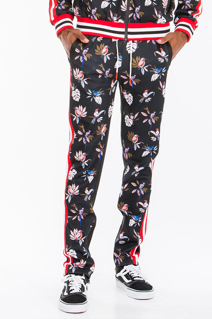 Black floral print slim track pants with red side stripe and striped ankle cuffs