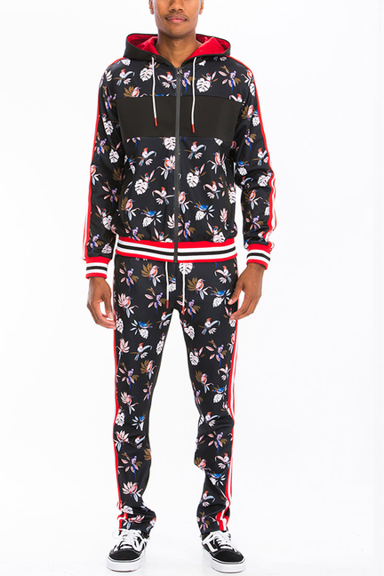 Black floral print zip track set with hood, red drawstring, and striped cuffs