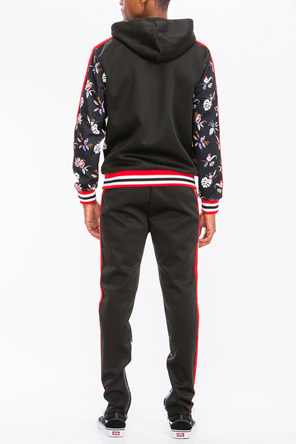 Black floral print track set back view with hood, striped hem, and red side stripes