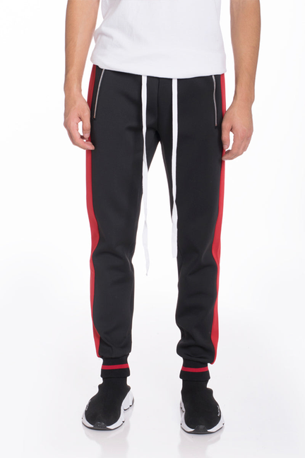 Black track pants with red vertical stripes and white side panels