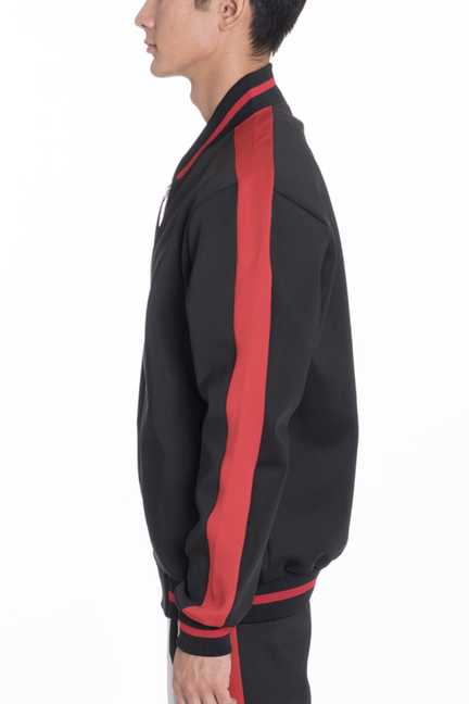 Black track jacket sleeve with bold red stripe and ribbed cuff