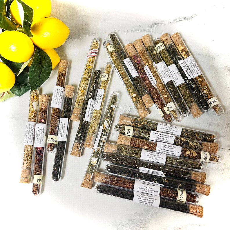 Assorted loose leaf tea test tubes with corks and ingredient labels, mixed colors