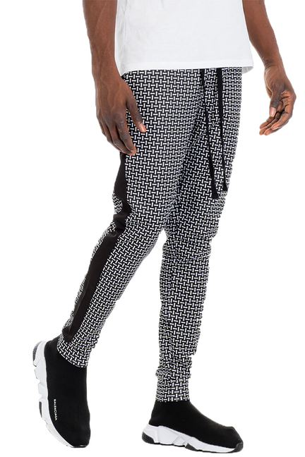 Black and white patterned track pants with ribbed ankle cuffs.