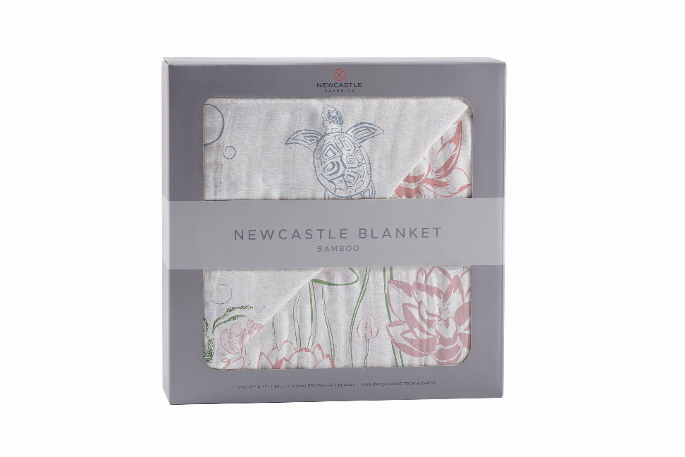 Bamboo baby blanket with light gray base, sea turtle and pink floral pattern