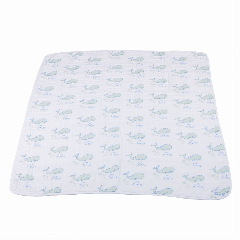Cotton muslin blanket with all-over light blue whale pattern, flat