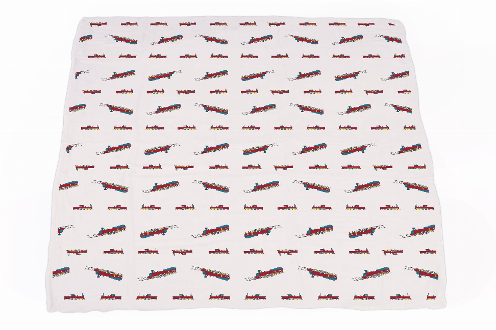 Bamboo blanket with repeating steam train pattern on white fabric
