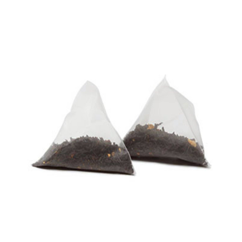 Two white tea sachets filled with dark tea leaves