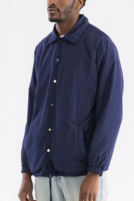 Navy coachs jacket with button front, collar, long sleeves and elastic cuffs