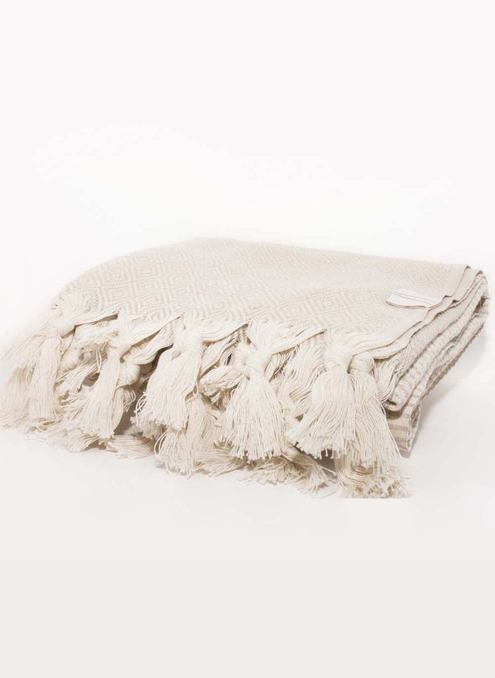 MEDI towel in cream with geometric pattern and long tassel fringe, folded