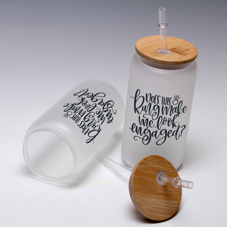 White mason jar tumbler with black script “Engaged?” and bamboo lid with straw