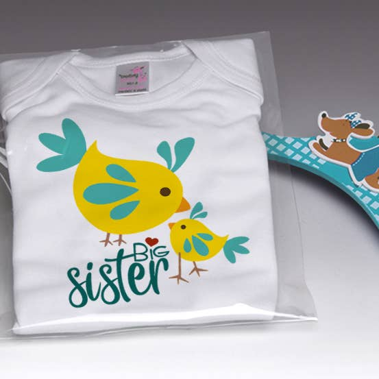 White baby onesie with yellow and teal bird graphic and 'Big sister' text