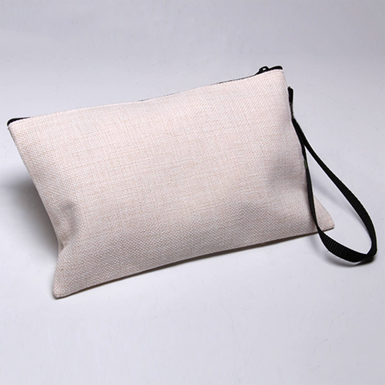 Beige rectangular pouch clutch with black wrist strap and zip closure