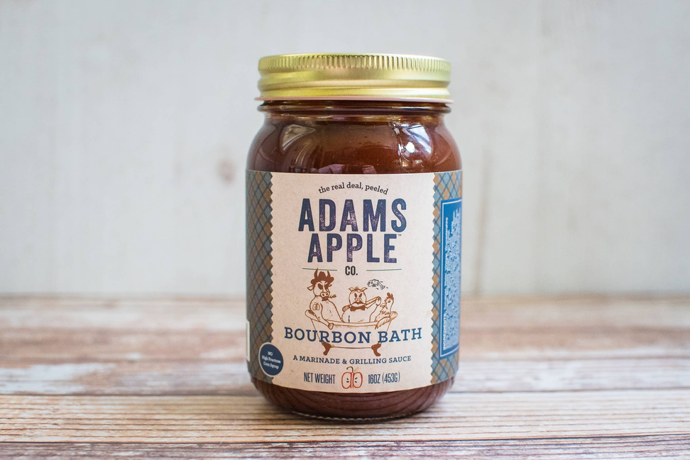 Adams Apple Bourbon Bath jar with gold lid on wooden surface