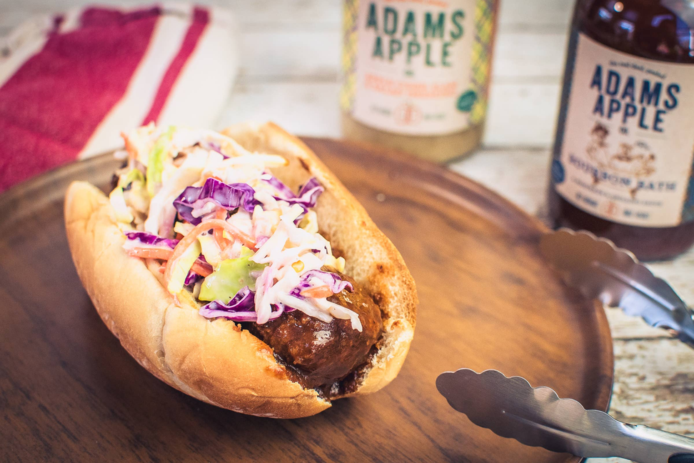Bourbon bath pulled meat sandwich on a bun with shredded cabbage