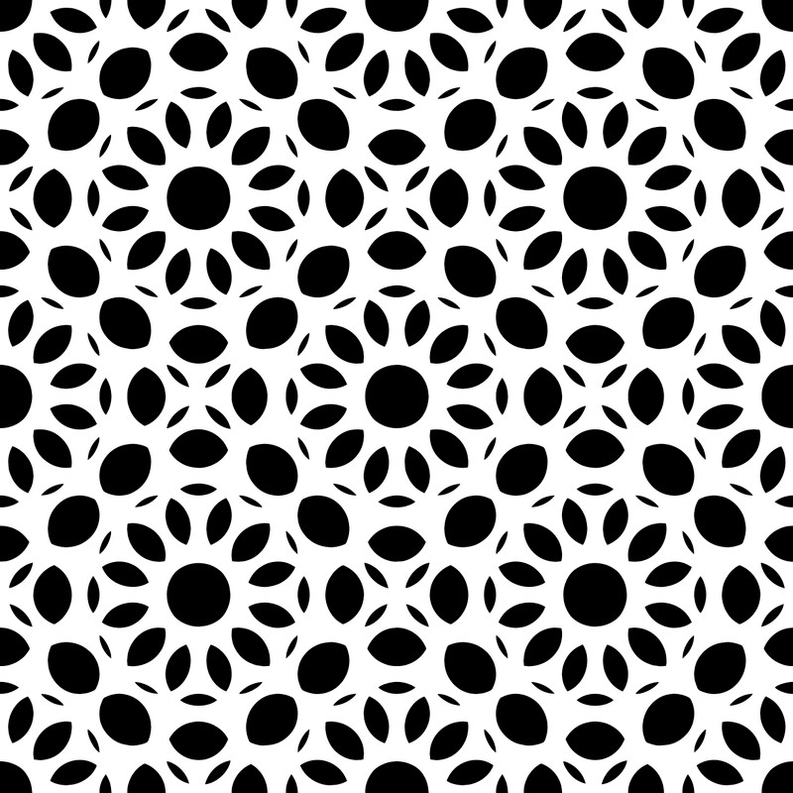 Close-up of peel-and-stick wallpaper with repeating black leaf-and-flower pattern on white