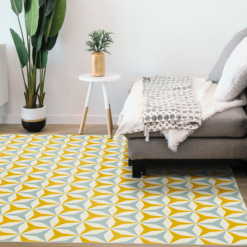 Geometric area rug in yellow and blue with star tile pattern on the floor