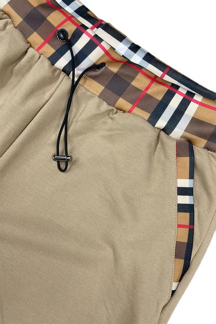 Khaki drawstring shorts with plaid side panels and checkered trim