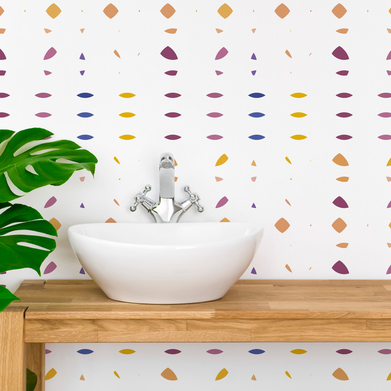 Peel-and-stick wallpaper with multicolor dot shapes on white, close-up view