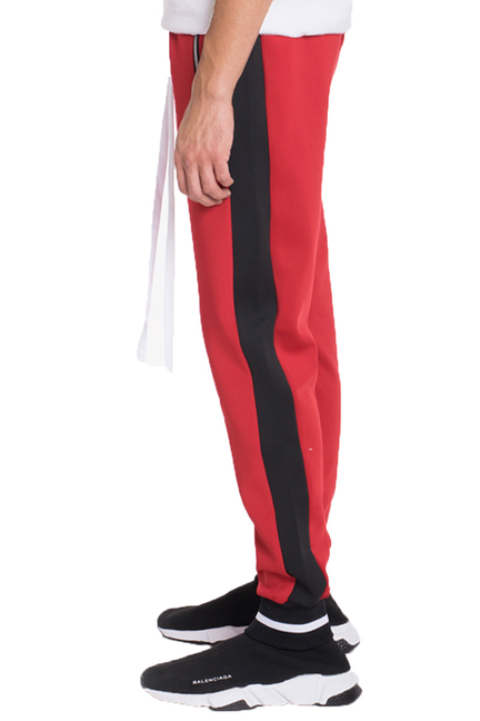 Red heavy-weight jogger pants with black side stripe and tapered leg cuffs