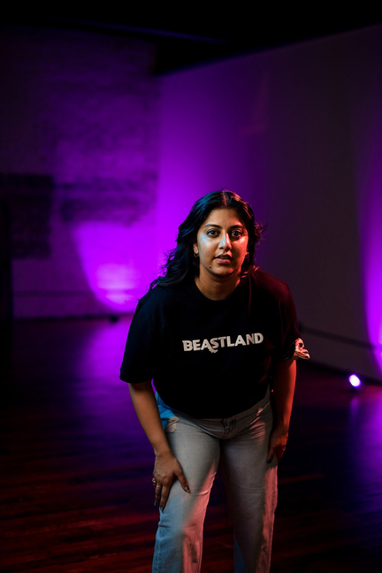 Black crew-neck graphic T-shirt with BEASTLAND text, short sleeves.