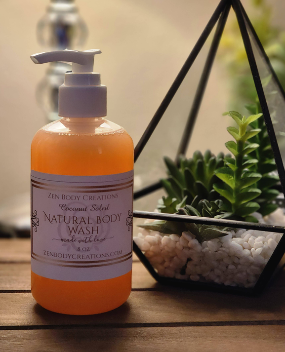 Natural body wash bottle with pump, orange liquid and front label close-up