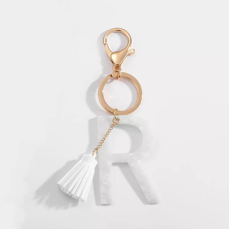 White tassel initial key chain with gold ring and letter R charm