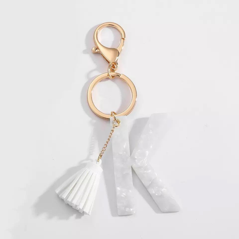 White K initial tassel key chain with gold rings and split-letter charm