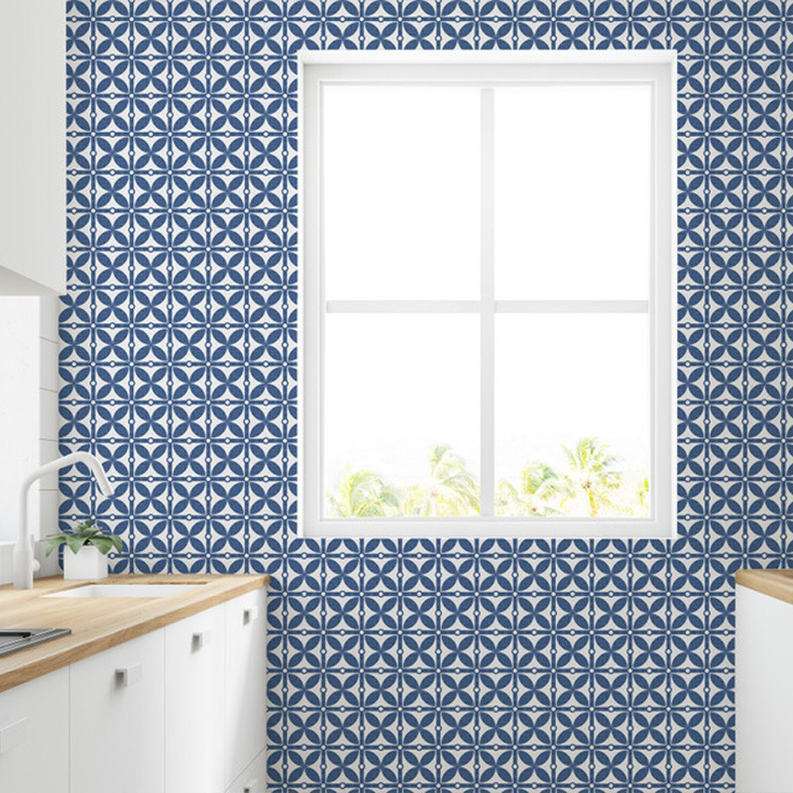 Peel-and-stick medallion wallpaper in blue and white pattern on wall with window