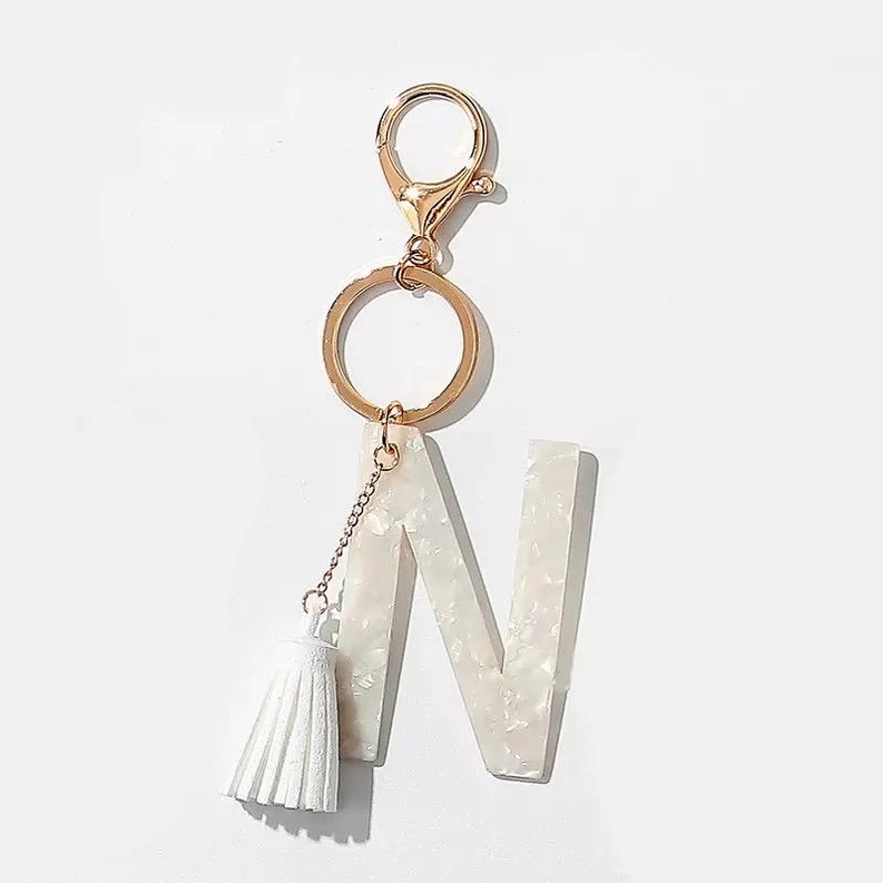 White initial N key chain with gold rings and tassel charm