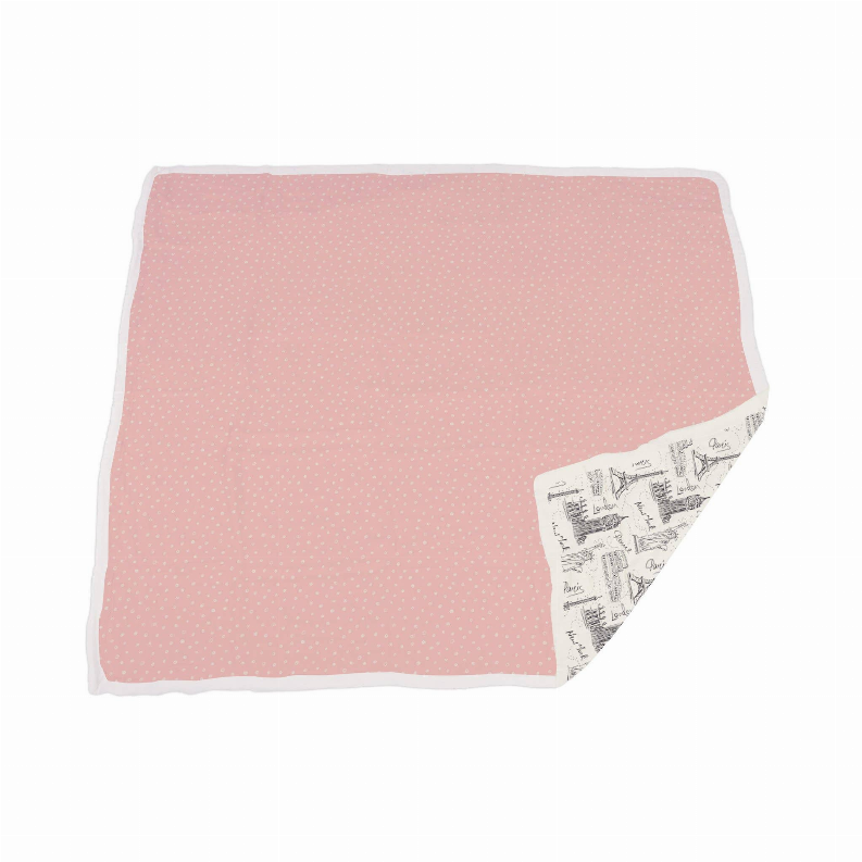 Pink bamboo blanket with small dot pattern, folded corner shows white print