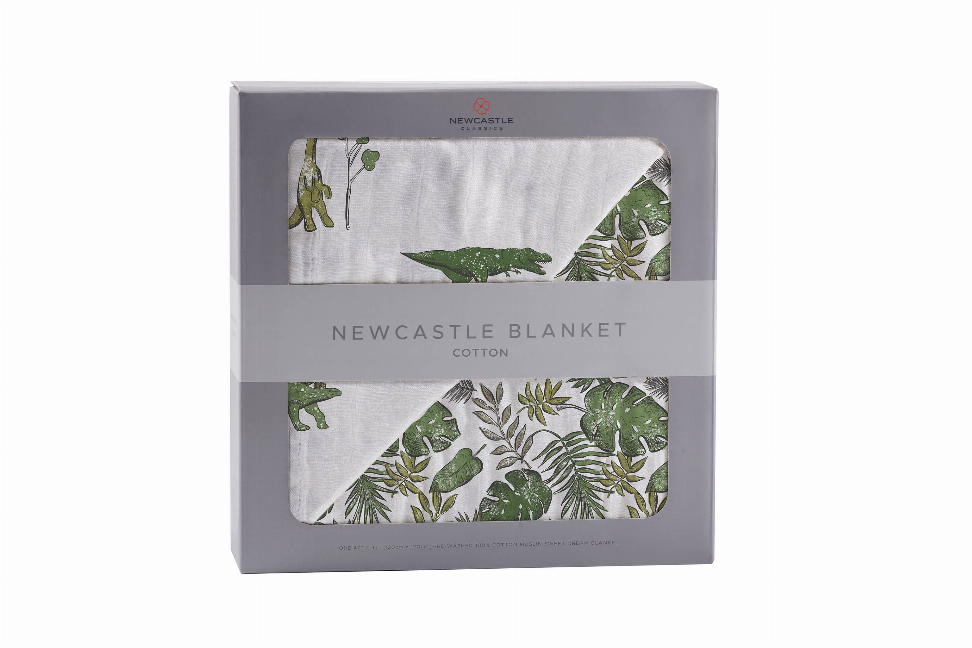 Cotton blanket in gift box, folded view with dino and jungle leaf prints