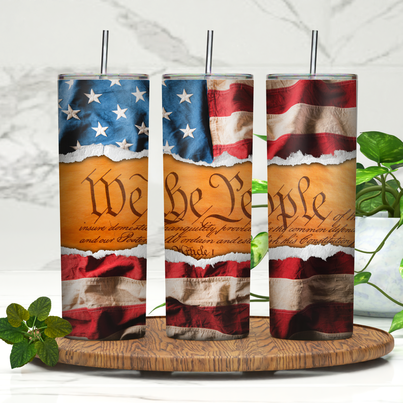 Patriotic American flag skinny tumbler with black straw, shown in a set of three on wood
